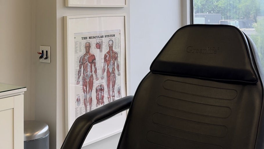Modern therapy chair at Injectme.Toronto, Toronto, Ontario, CA, with anatomical posters.