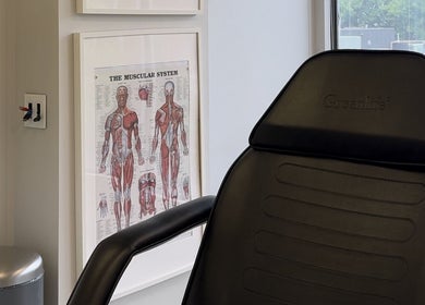 Modern therapy chair at Injectme.Toronto, Toronto, Ontario, CA, with anatomical posters.
