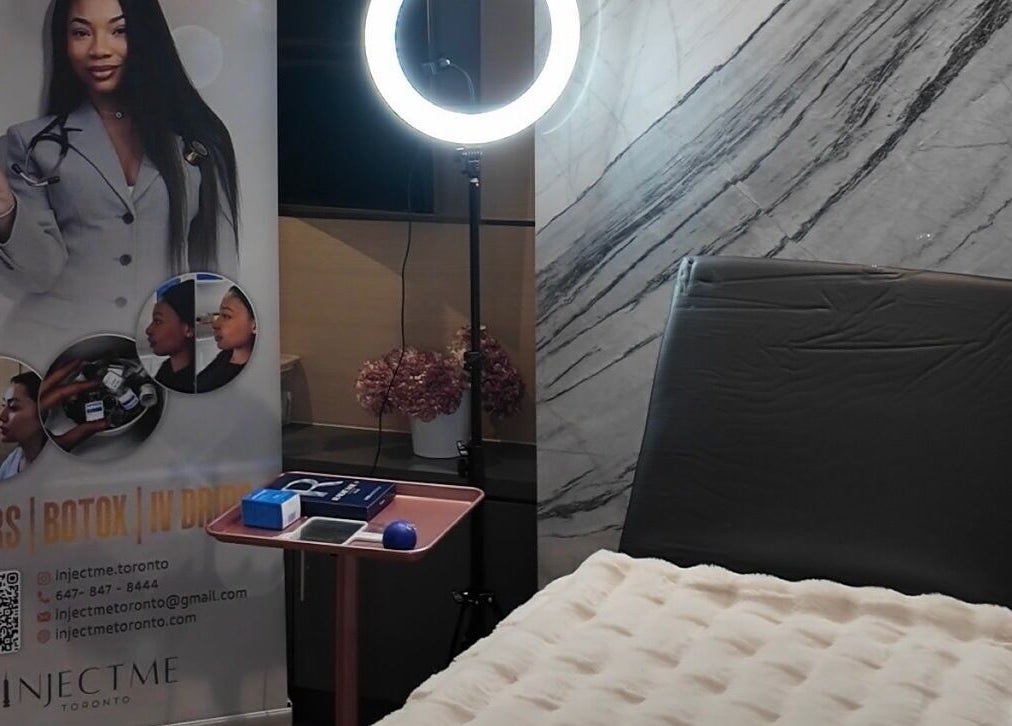 Injectme.Toronto wellness room in Toronto, Ontario, CA, featuring a modern chair and promotional display.