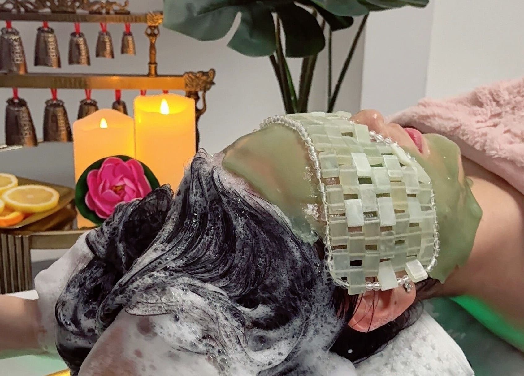 Relaxing spa treatment at Sky Head Spa in San Jose, California, US with candles and herbal mask.