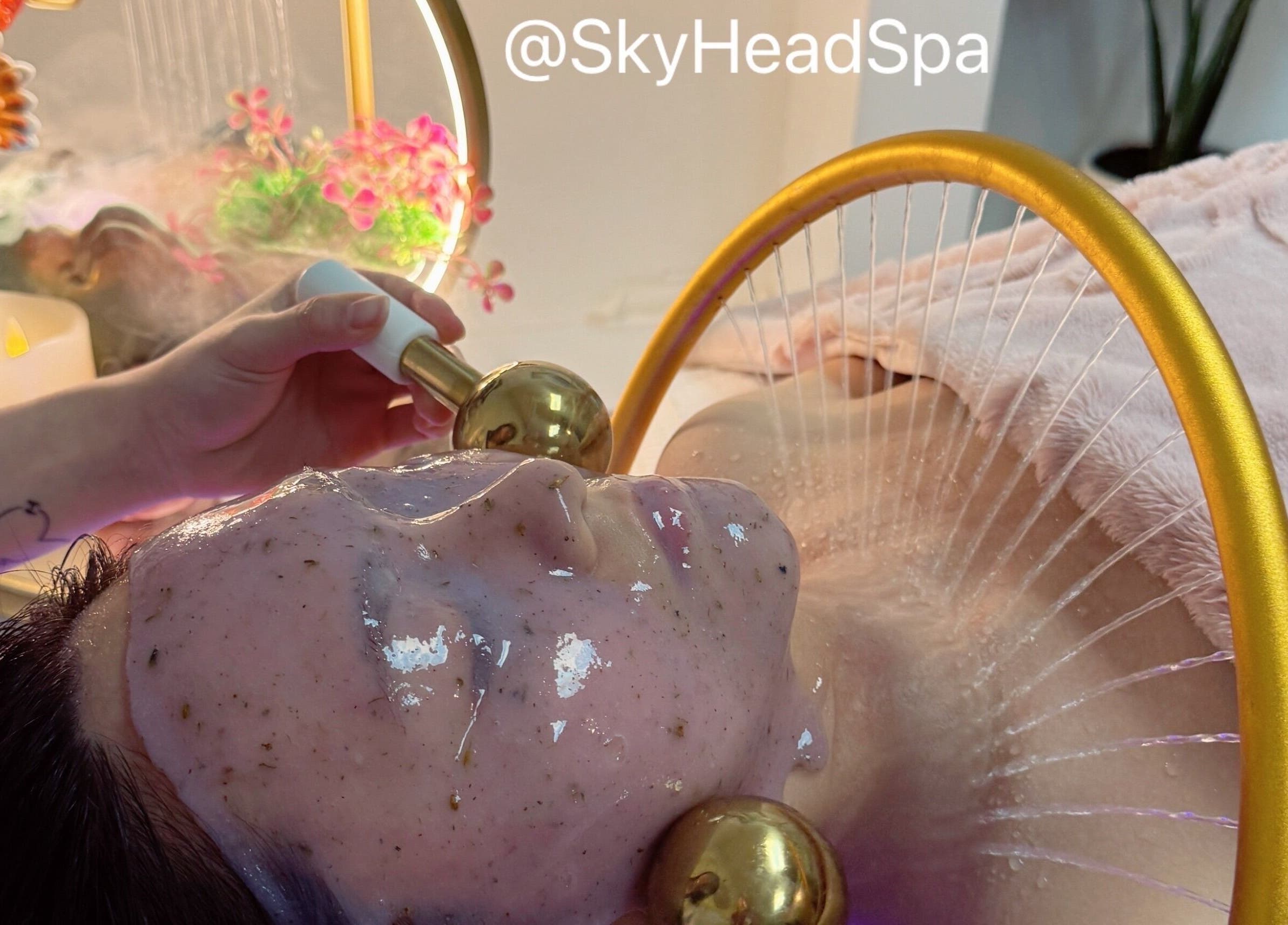 Luxurious facial treatment at Sky Head Spa in San Jose, California, US, featuring golden massage tools.