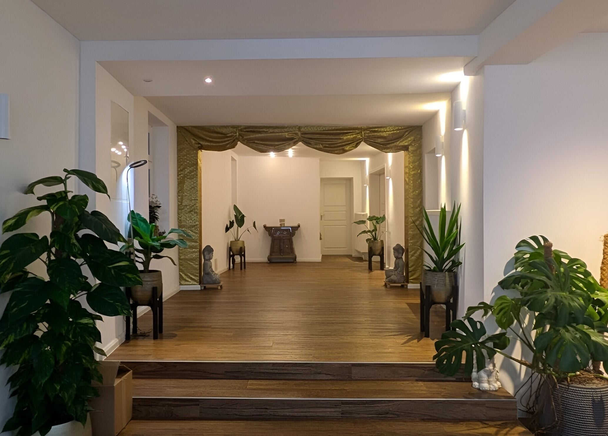 Eingangsbereich von Baramie, Gau-algesheim, Rheinland-pfalz, DE mit Pflanzen und Buddha-Statuen.