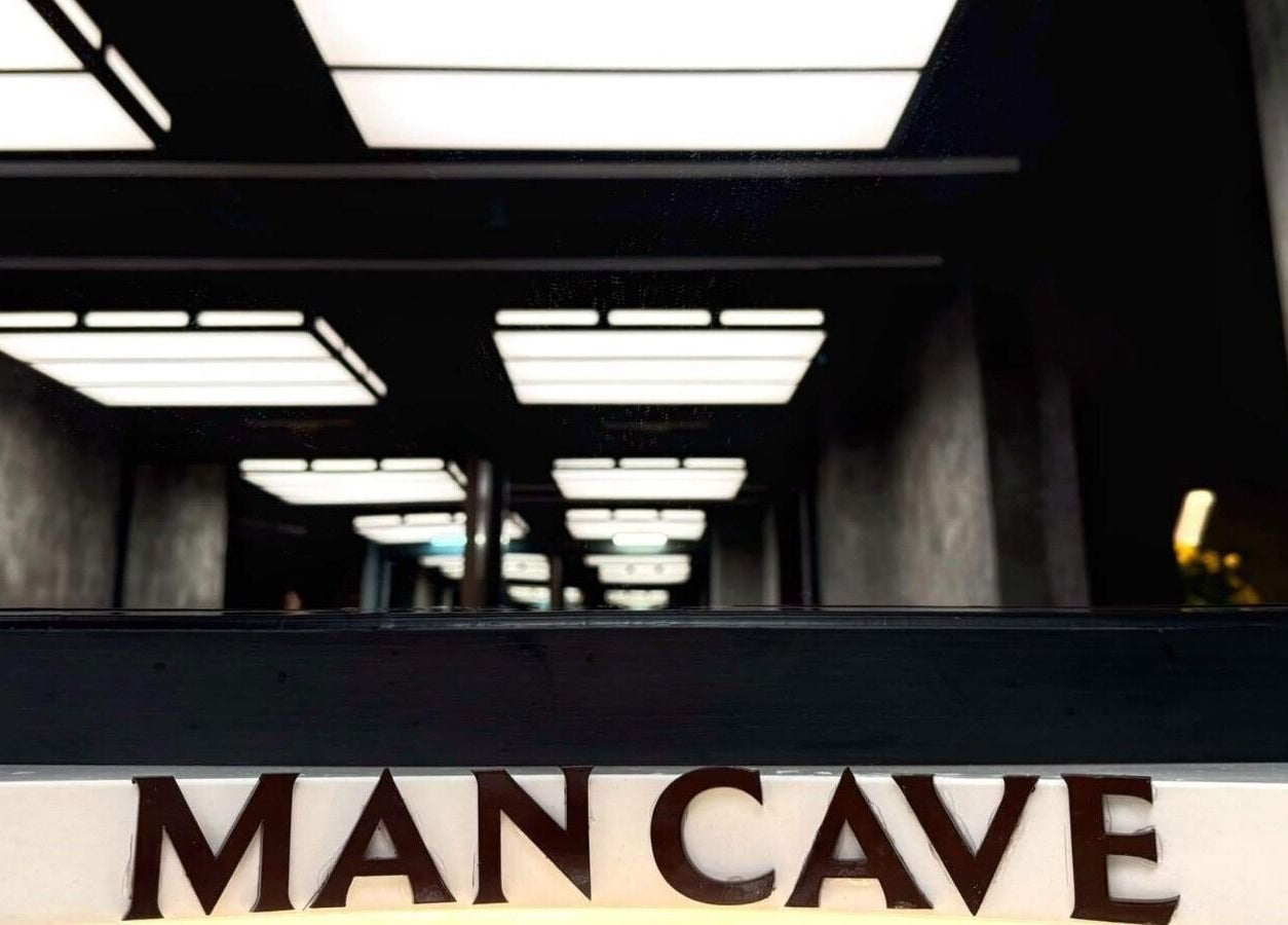 Modern interior of MAN CAVE - Barber Lounge in Yangon, Yangon Region, MM with stylish ceiling lighting.