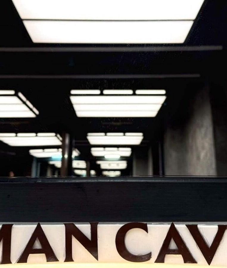 Modern interior of MAN CAVE - Barber Lounge in Yangon, Yangon Region, MM with stylish ceiling lighting.