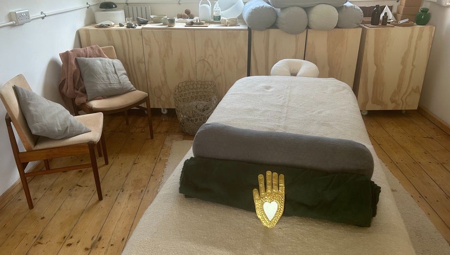 Cozy spa room at Faelt in Birmingham, England, GB featuring a massage bed and warm wood accents.