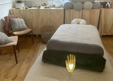 Cozy spa room at Faelt in Birmingham, England, GB featuring a massage bed and warm wood accents.