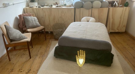 Cozy spa room at Faelt in Birmingham, England, GB featuring a massage bed and warm wood accents.