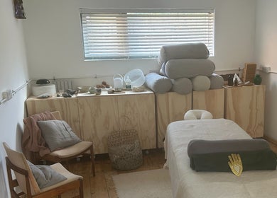 Cozy spa room at Faelt in Birmingham, England, GB featuring a massage table and comfortable seating.