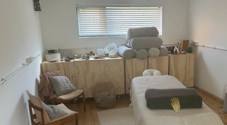Cozy spa room at Faelt in Birmingham, England, GB featuring a massage table and comfortable seating.