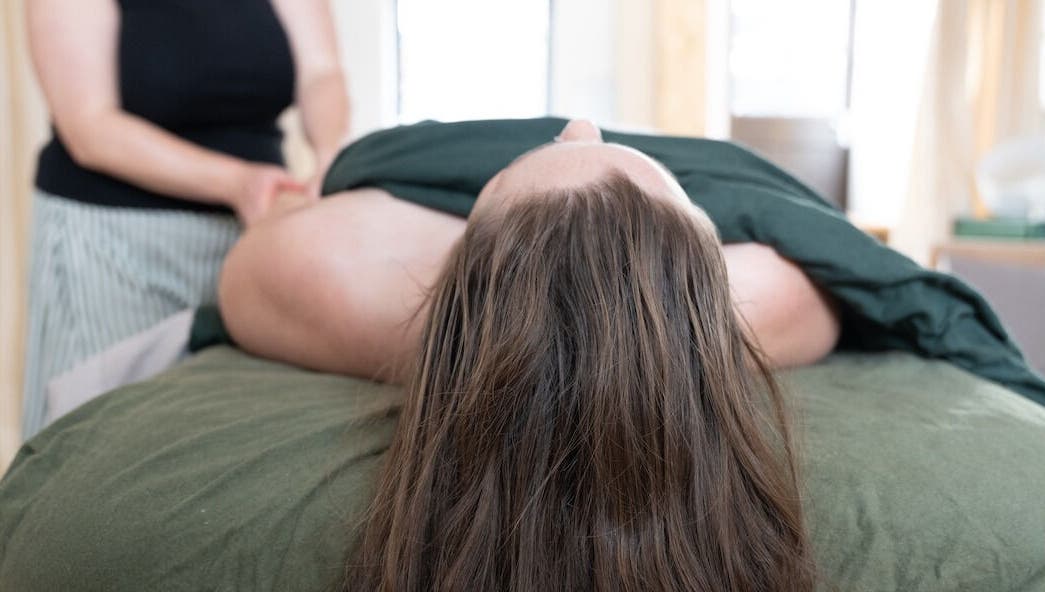 Massage therapy session at Faelt Studio in Birmingham, England, GB offers a serene wellness experience.