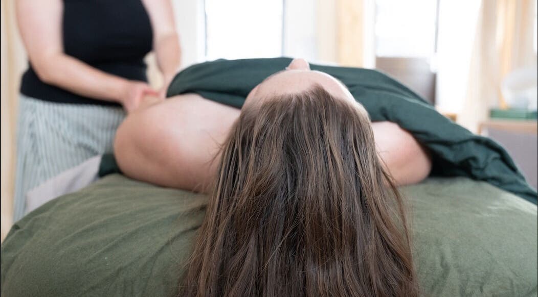 Massage therapy session at Faelt Studio in Birmingham, England, GB offers a serene wellness experience.