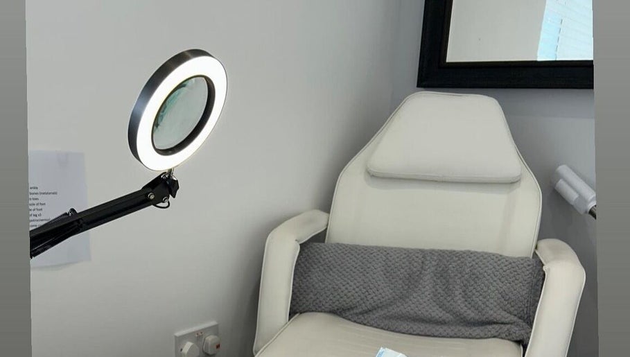 Treatment chair in Nikki Porter FHP, a serene room in Birmingham, England, GB, featuring modern lighting.