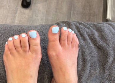 Freshly pedicured toes with light blue polish at Nikki Porter FHP, Birmingham, England, GB.