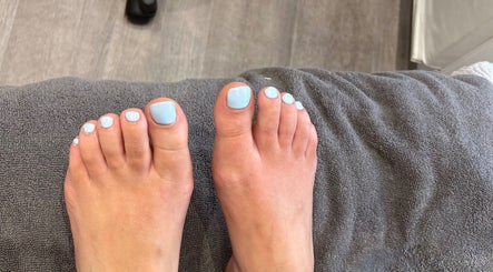 Freshly pedicured toes with light blue polish at Nikki Porter FHP, Birmingham, England, GB.