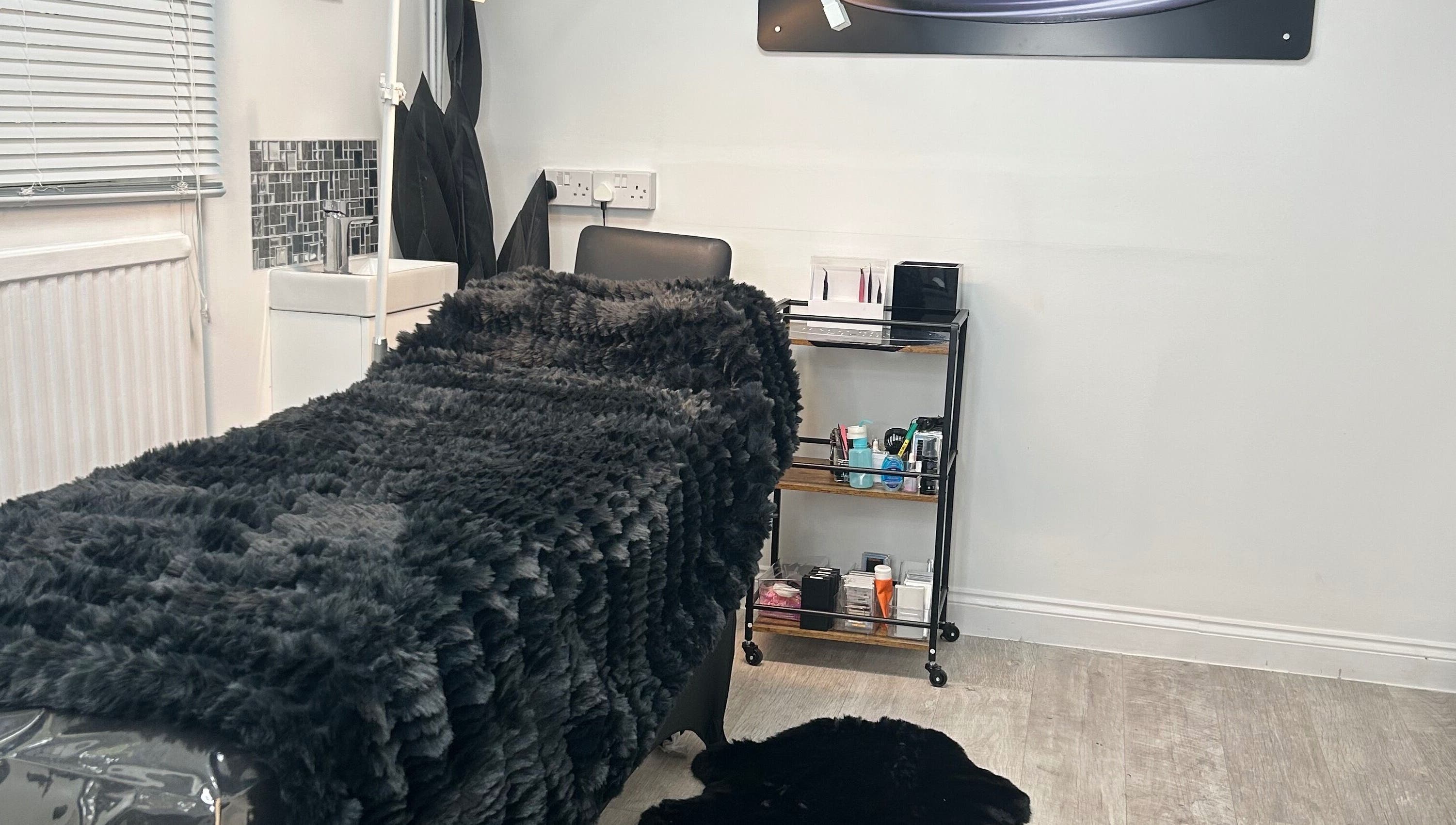 Cozy treatment bed at Halo Beauty Studio in Letchworth Garden City, England, GB, showcasing a serene ambiance.