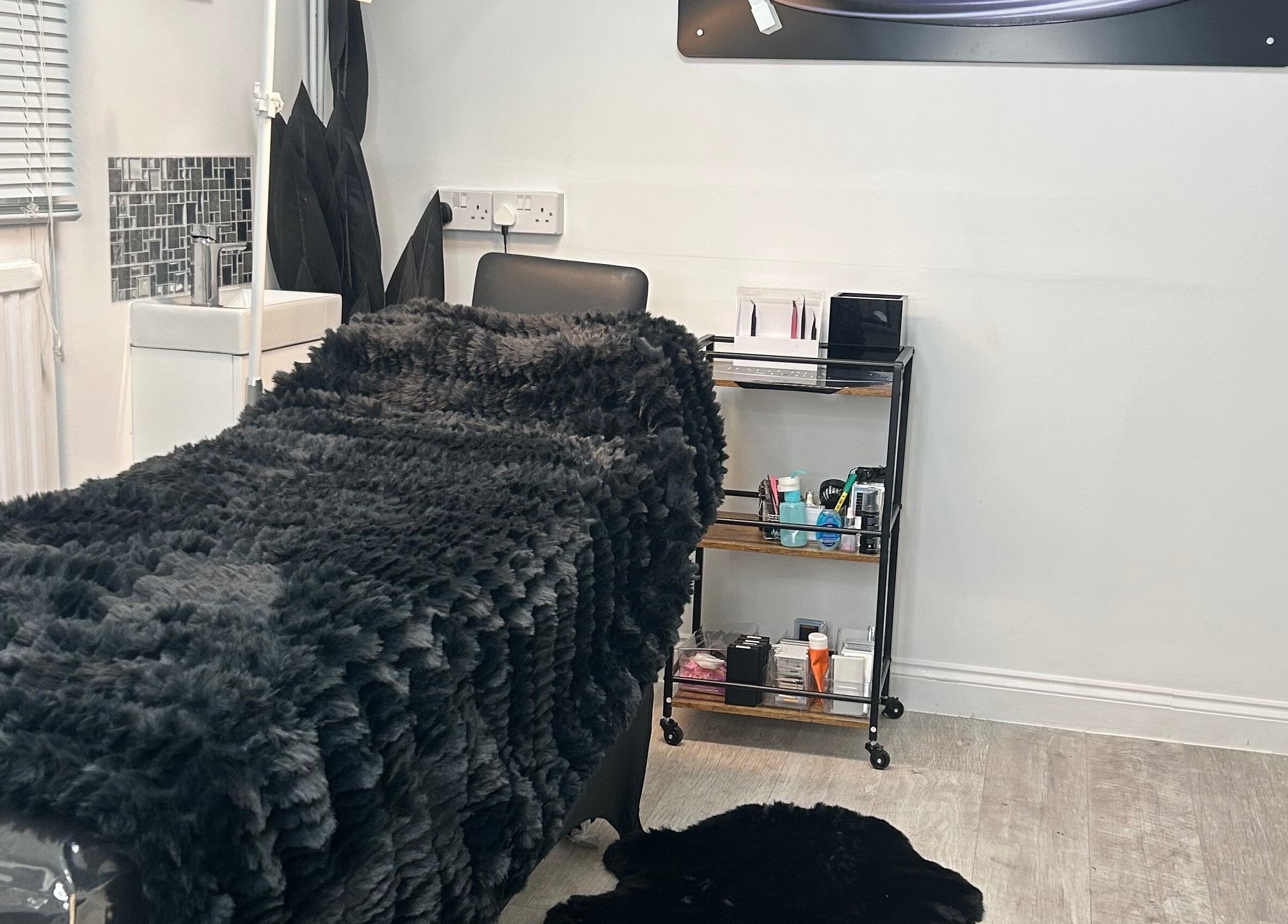 Cozy treatment bed at Halo Beauty Studio in Letchworth Garden City, England, GB, showcasing a serene ambiance.