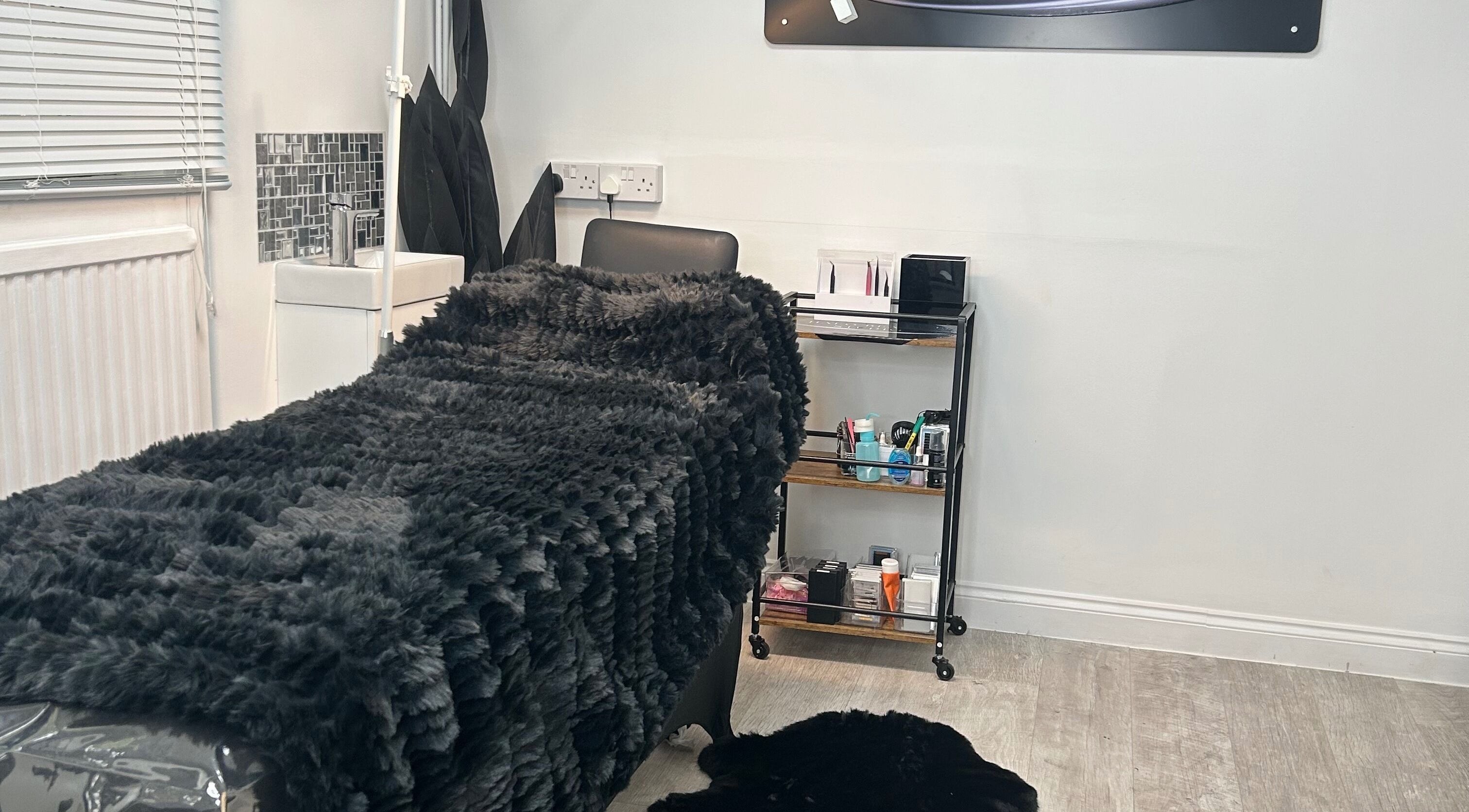 Cozy treatment bed at Halo Beauty Studio in Letchworth Garden City, England, GB, showcasing a serene ambiance.