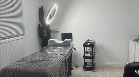 Treatment room at Halo Beauty Hatfield, Hatfield, England, GB with a table, chair, and skincare cart.