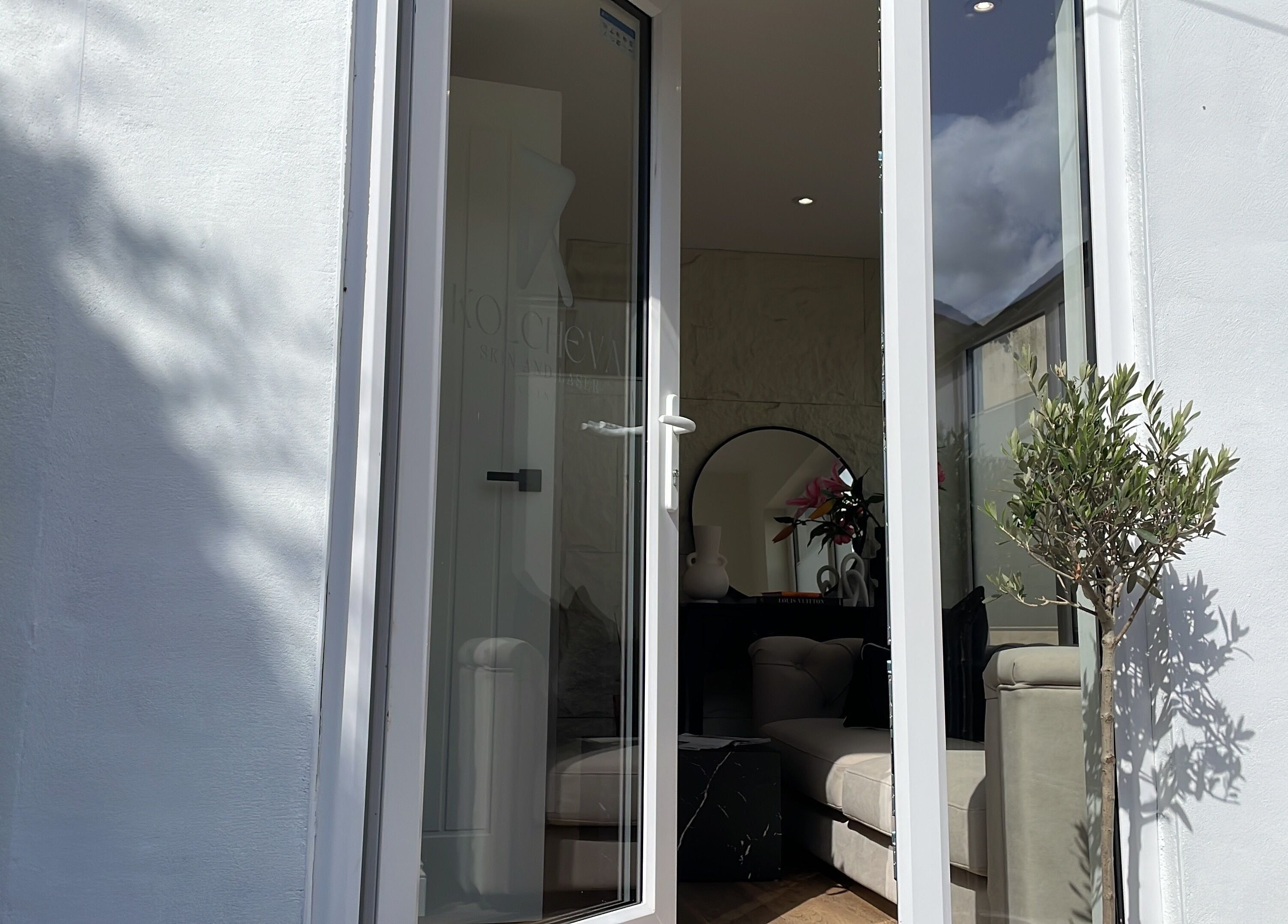 Open glass door at Kolcheva Skin & Laser Clinic, Kirkham, England, GB, showcasing interior elegance.
