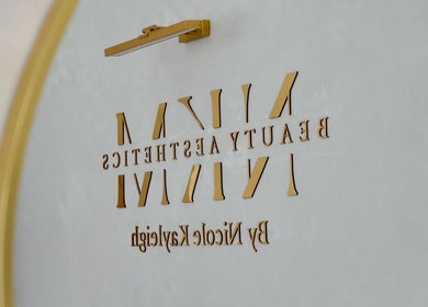Elegant golden logo for By Nicole Kayleigh at Fleetwood, England, GB, reflecting beauty and aesthetics.