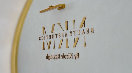 Elegant golden logo for By Nicole Kayleigh at Fleetwood, England, GB, reflecting beauty and aesthetics.