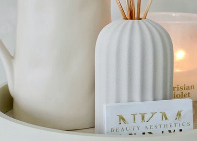 Serene ambience at By Nicole Kayleigh in Fleetwood, England, GB with candle and diffuser on tray.