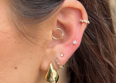 Close-up of stylish ear piercings at The beauty shack @ muse studio, Longwell Green, England, GB.