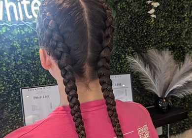 Woman with stylish braids at Bex at Lillywhite & Co., Wakefield, England, GB.