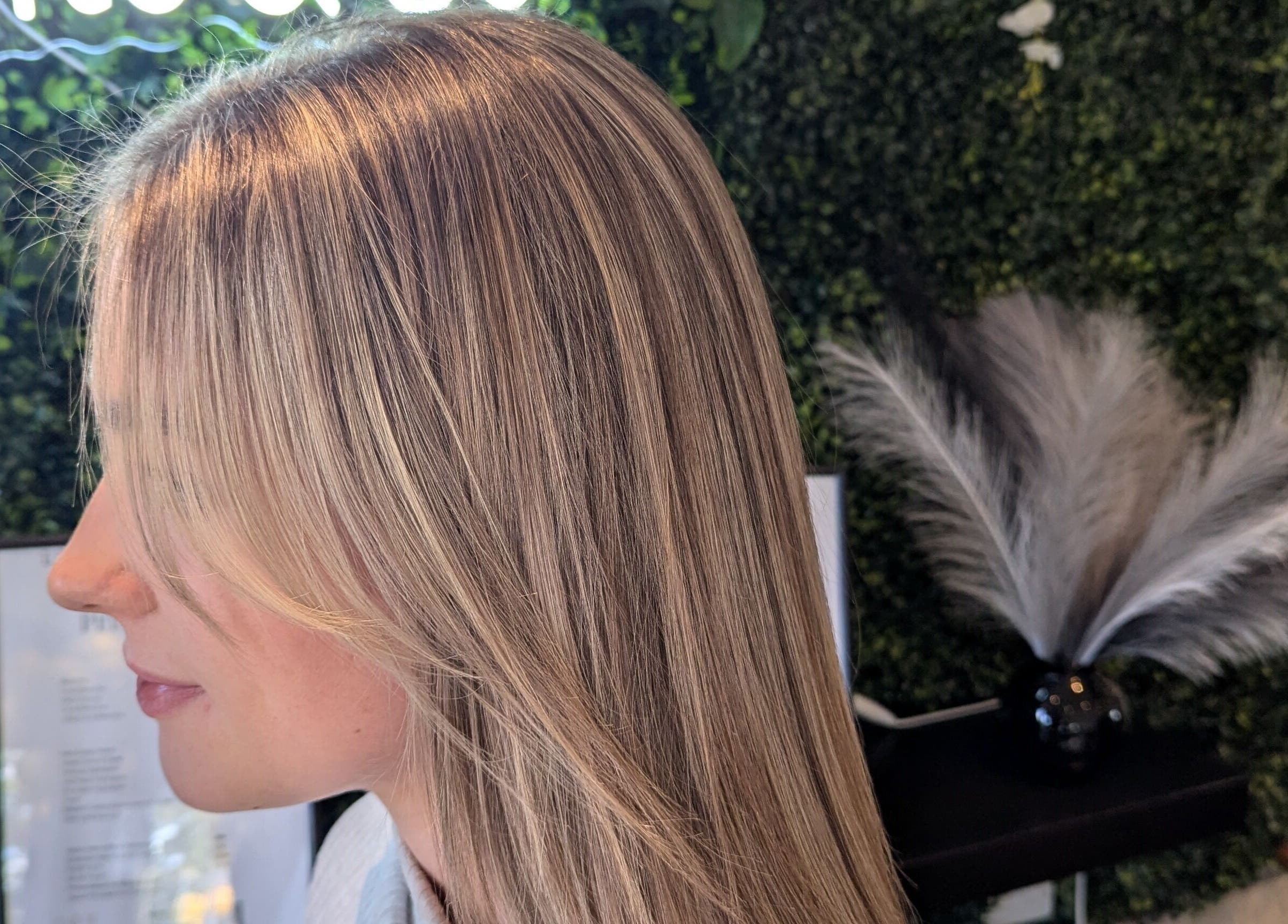 Lush blonde hairstyle at Bex at Lillywhite & Co., Wakefield, England, GB. Vibrant salon greenery backdrop.