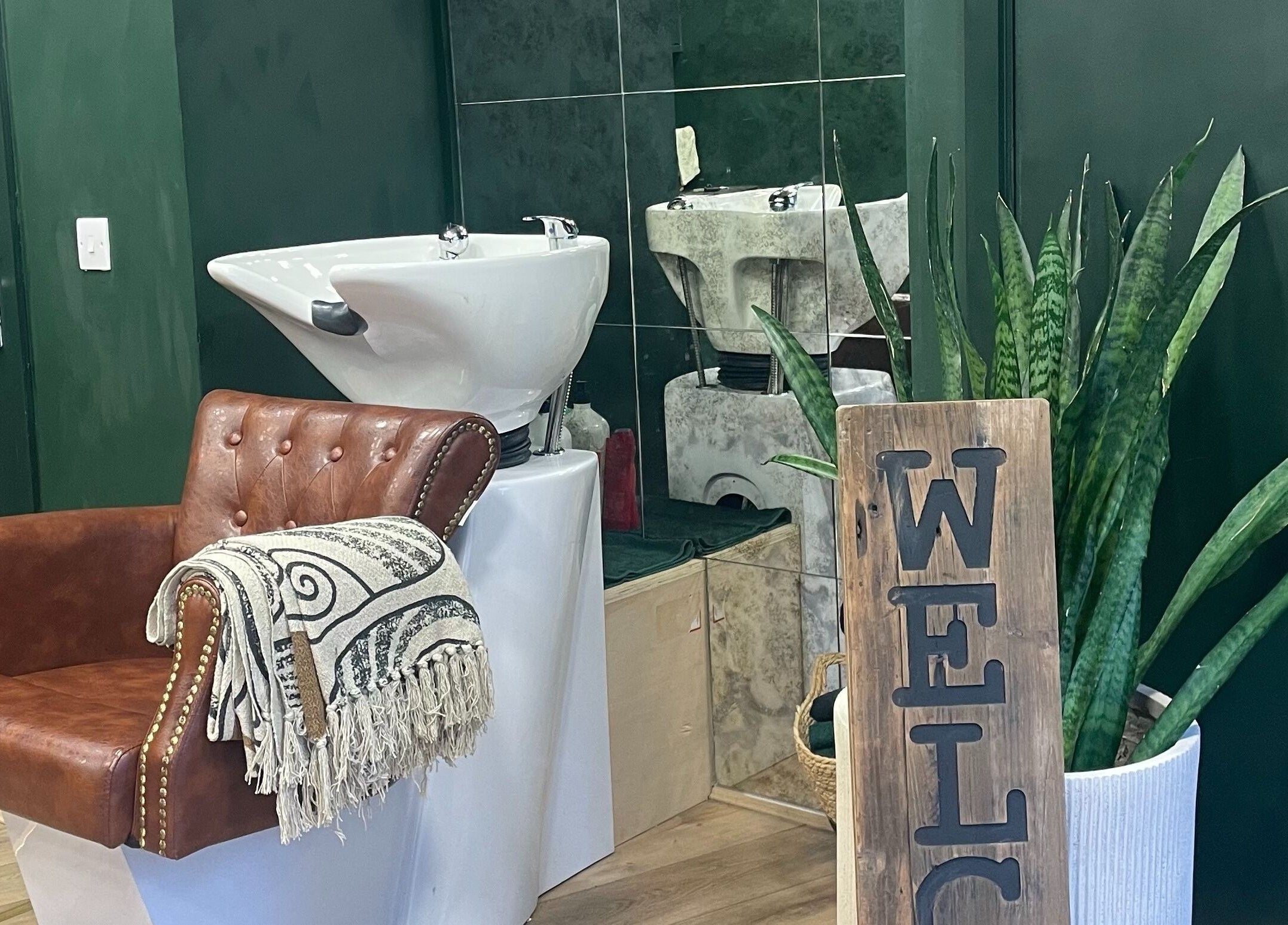 Inviting salon space at Koko - Emma, Cirencester, England, GB with elegant chair and lush greenery.