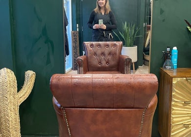 Chic salon interior at Koko - Emma, Cirencester, England, GB with leather chair and potted plants.
