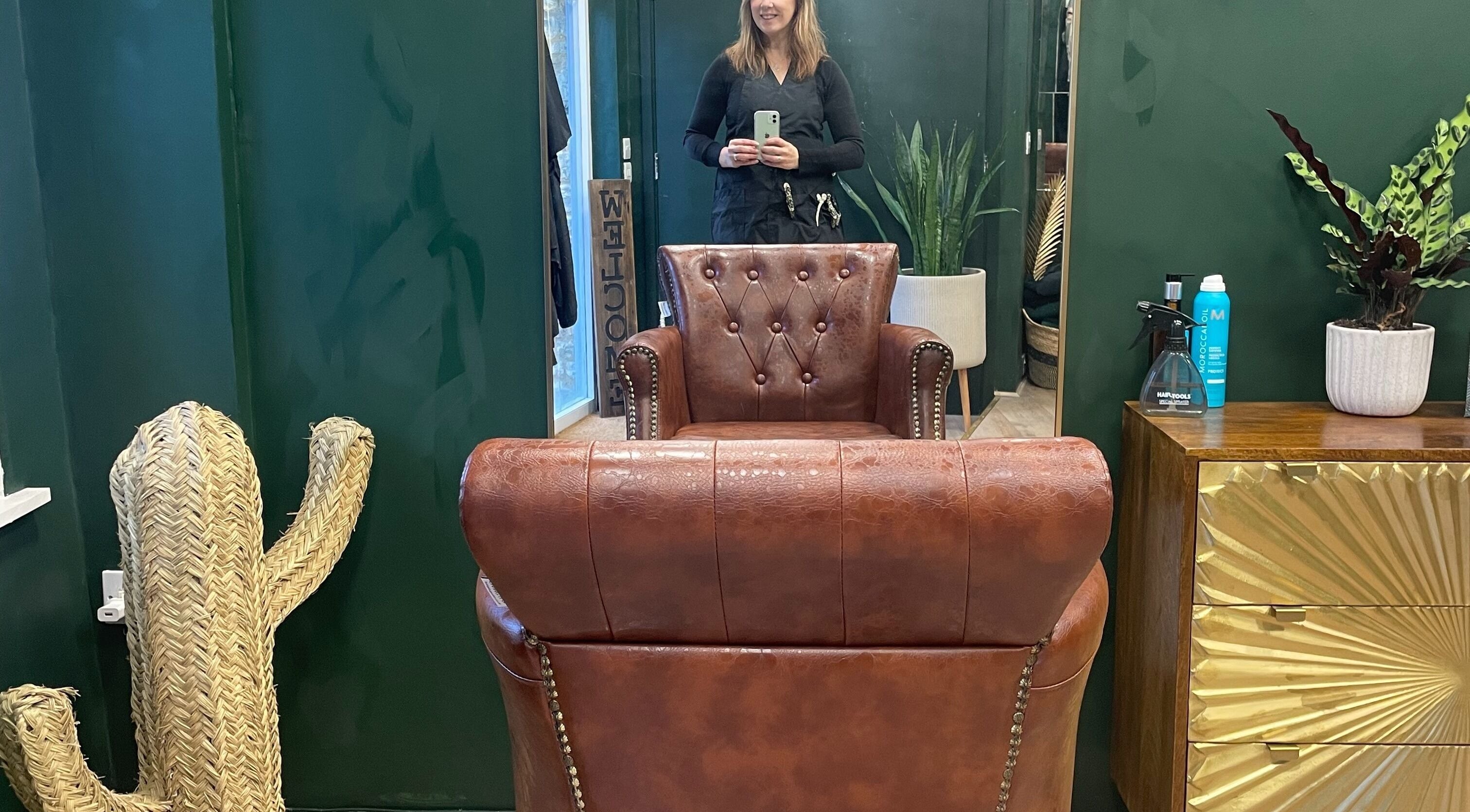 Chic salon interior at Koko - Emma, Cirencester, England, GB with leather chair and potted plants.