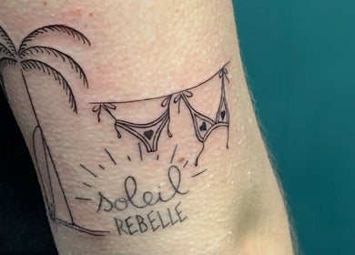 Tatouage 'Soleil Rebelle' sur bras à 94 Tatouage - Piercing et Formation, Orly, Île-de-France, FR.