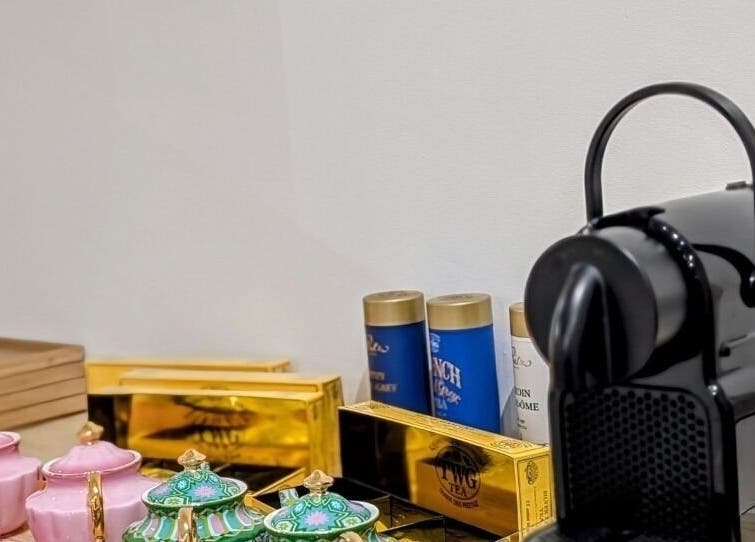 Tea and coffee setup at LAPIS WHITENING in Singapore, SG, featuring elegant cups and a sleek machine.