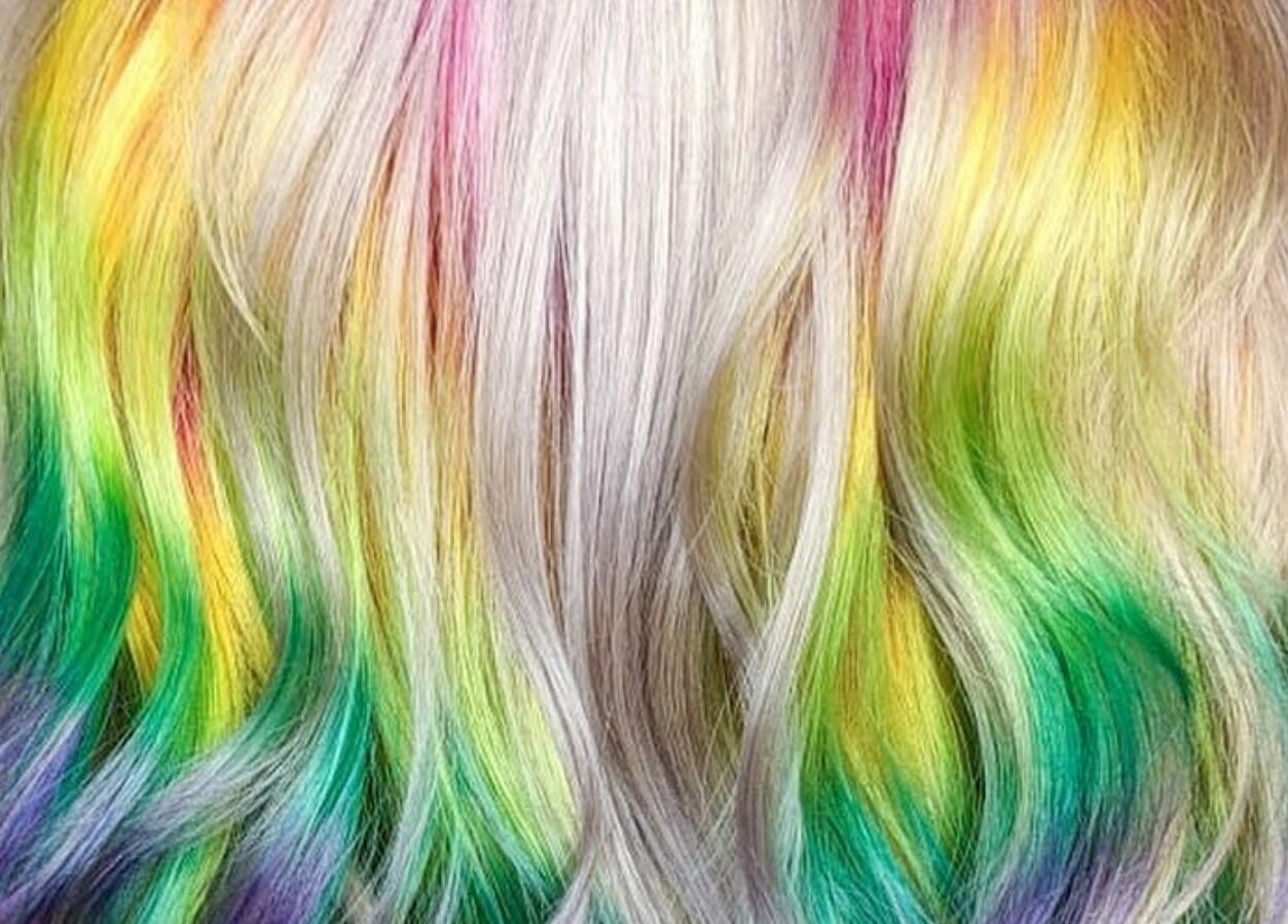Vibrant rainbow-colored hair styled at Outline Hair in Edinburgh, Scotland, GB.