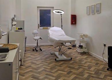 Relaxing treatment room at Faces Aesthetics, Cwm-twrch Isaf, Wales, GB, showcasing professional wellness facilities.