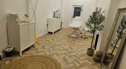 Elegant treatment room at Faces Aesthetics, Cwm-twrch Isaf, Wales, GB featuring modern decor and equipment.