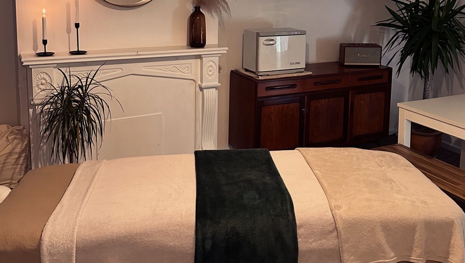 Tranquil massage room at Ruska, Poole, England, GB featuring plush towels and soothing decor.
