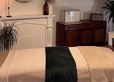 Tranquil massage room at Ruska, Poole, England, GB featuring plush towels and soothing decor.