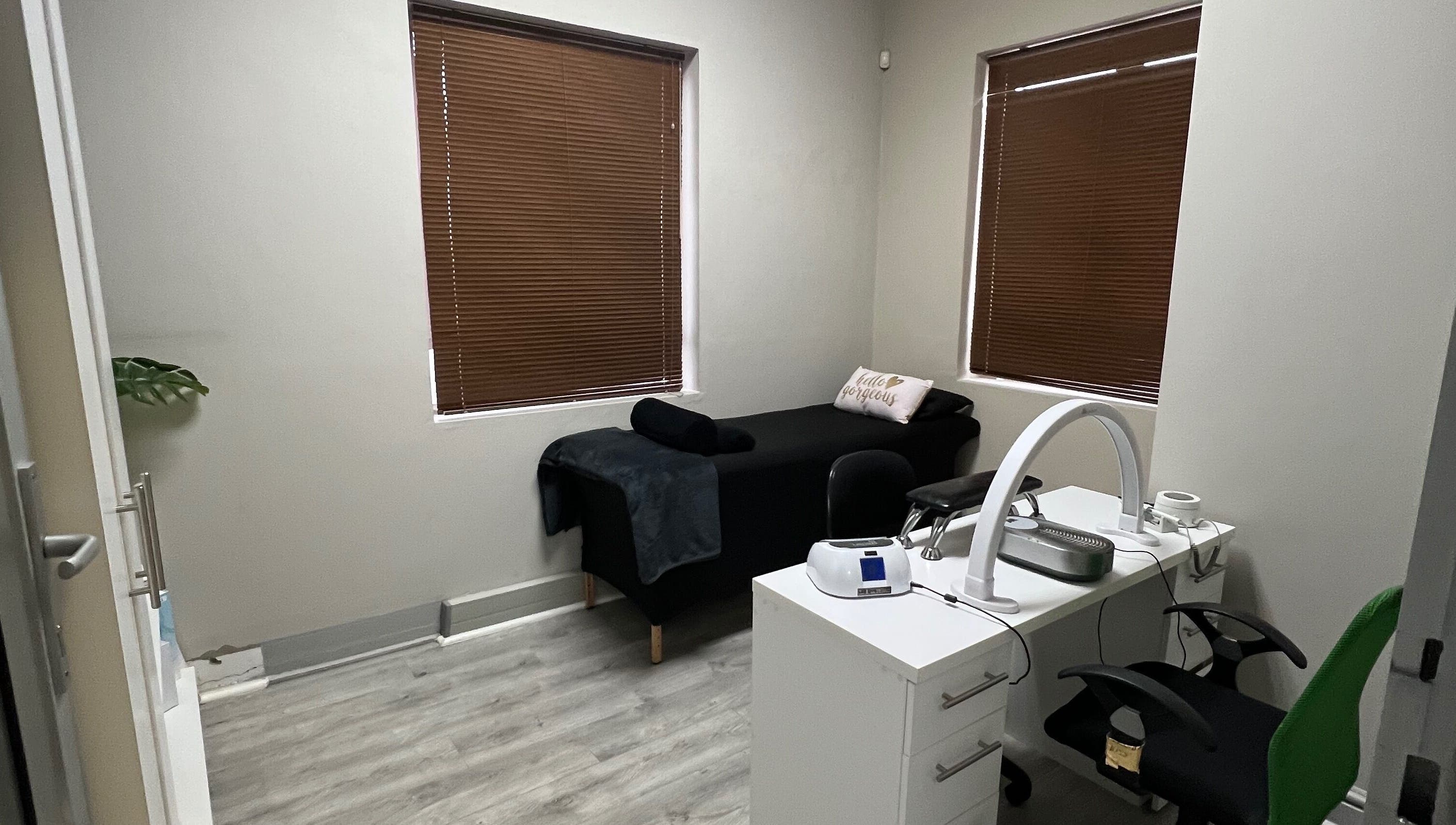 Cozy treatment room at Hush Nail Scape, Cape Town, Western Cape, ZA with massage bed and manicure station.