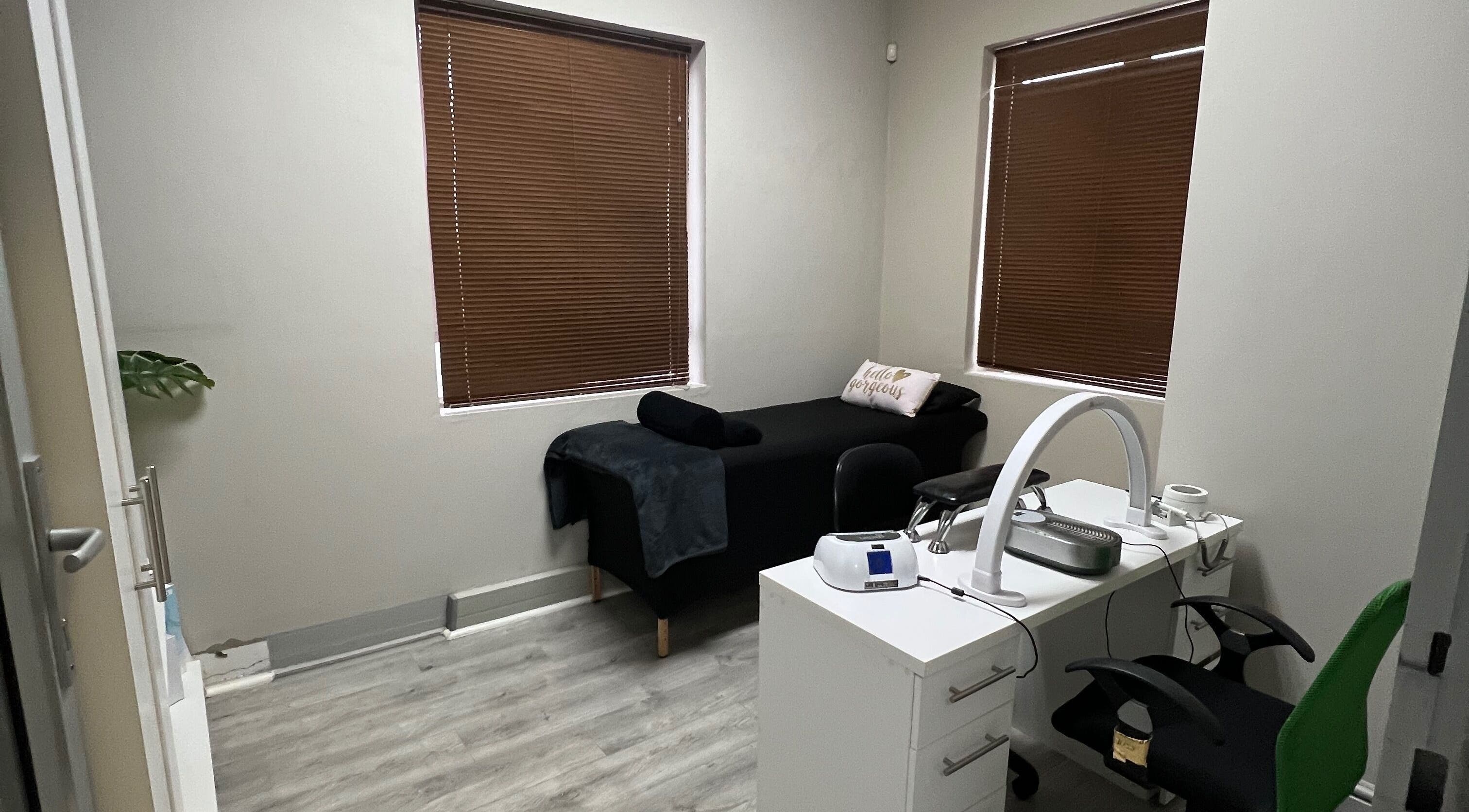 Cozy treatment room at Hush Nail Scape, Cape Town, Western Cape, ZA with massage bed and manicure station.