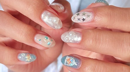 Elegant nail art with glitter and stars at ZozoStudio, Vancouver, British Columbia, CA.