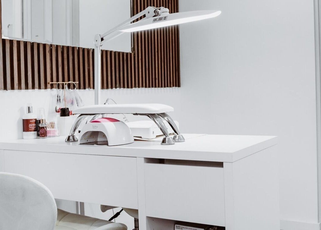 Modern manicure station at Just For You in Naxxar, MT, featuring sleek white design and nail care essentials.