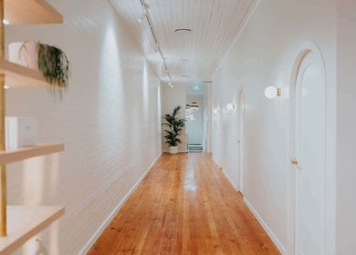 Elegant hallway at Lomani Day Spa, Toowoomba City, Queensland, AU with wooden floors and soft lighting.