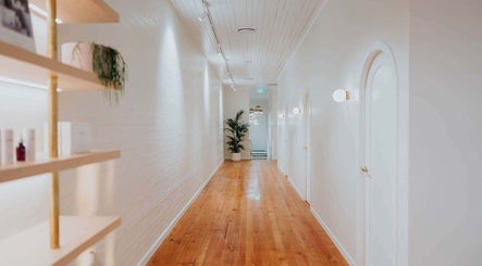 Elegant hallway at Lomani Day Spa, Toowoomba City, Queensland, AU with wooden floors and soft lighting.