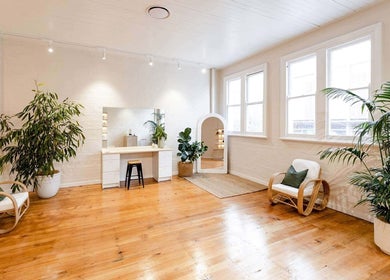 Bright, serene setting at Lomani Day Spa, Toowoomba City, Queensland, AU with inviting chairs and lush plants.