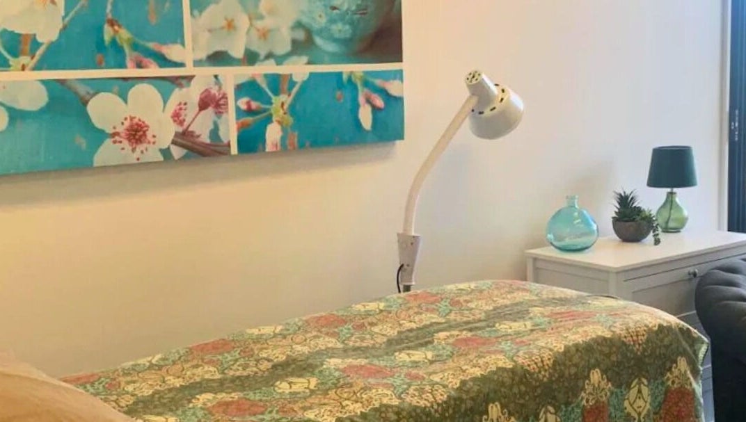 Therapy room at Golden Crown Healing (Sunshine Coast), Coolum Beach with floral decor and soft lighting.