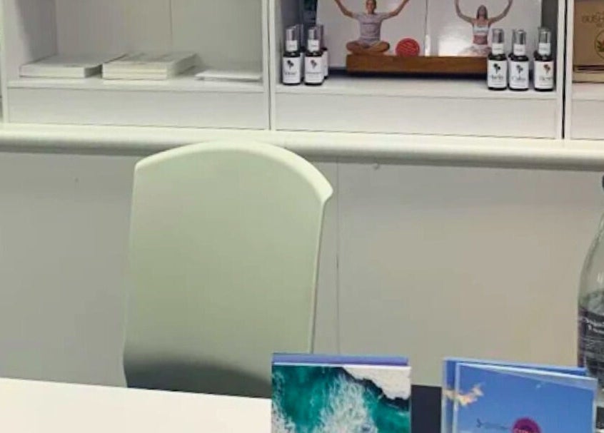 Reception desk with wellness products at Golden Crown Healing, Coolum Beach, Queensland, AU.
