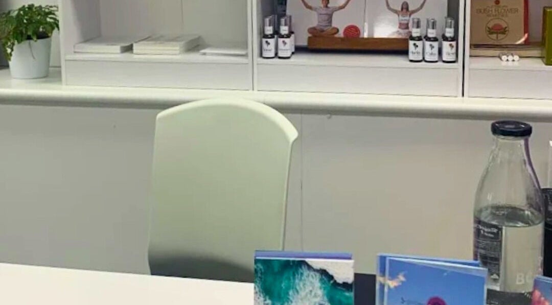Reception desk with wellness products at Golden Crown Healing, Coolum Beach, Queensland, AU.