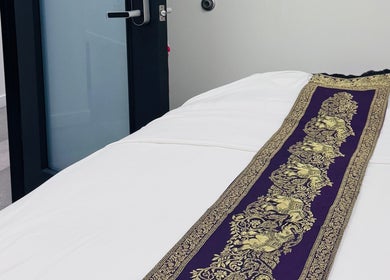 Massage table with ornate Thai fabric at Disara Thai Massage, Las Vegas, Nevada, US.